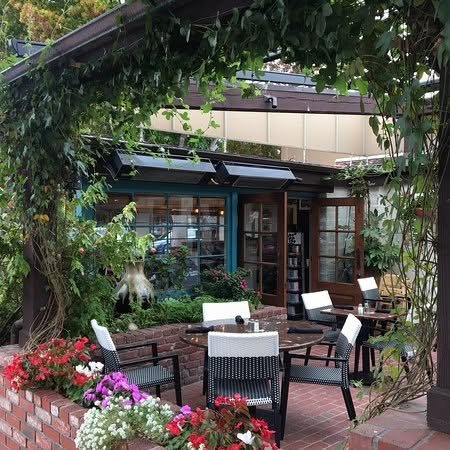 The flower-lined brick garden patio